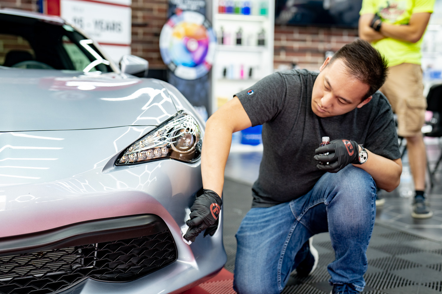 A Fireball Installer coats a car with Fireball Ceramic Coating