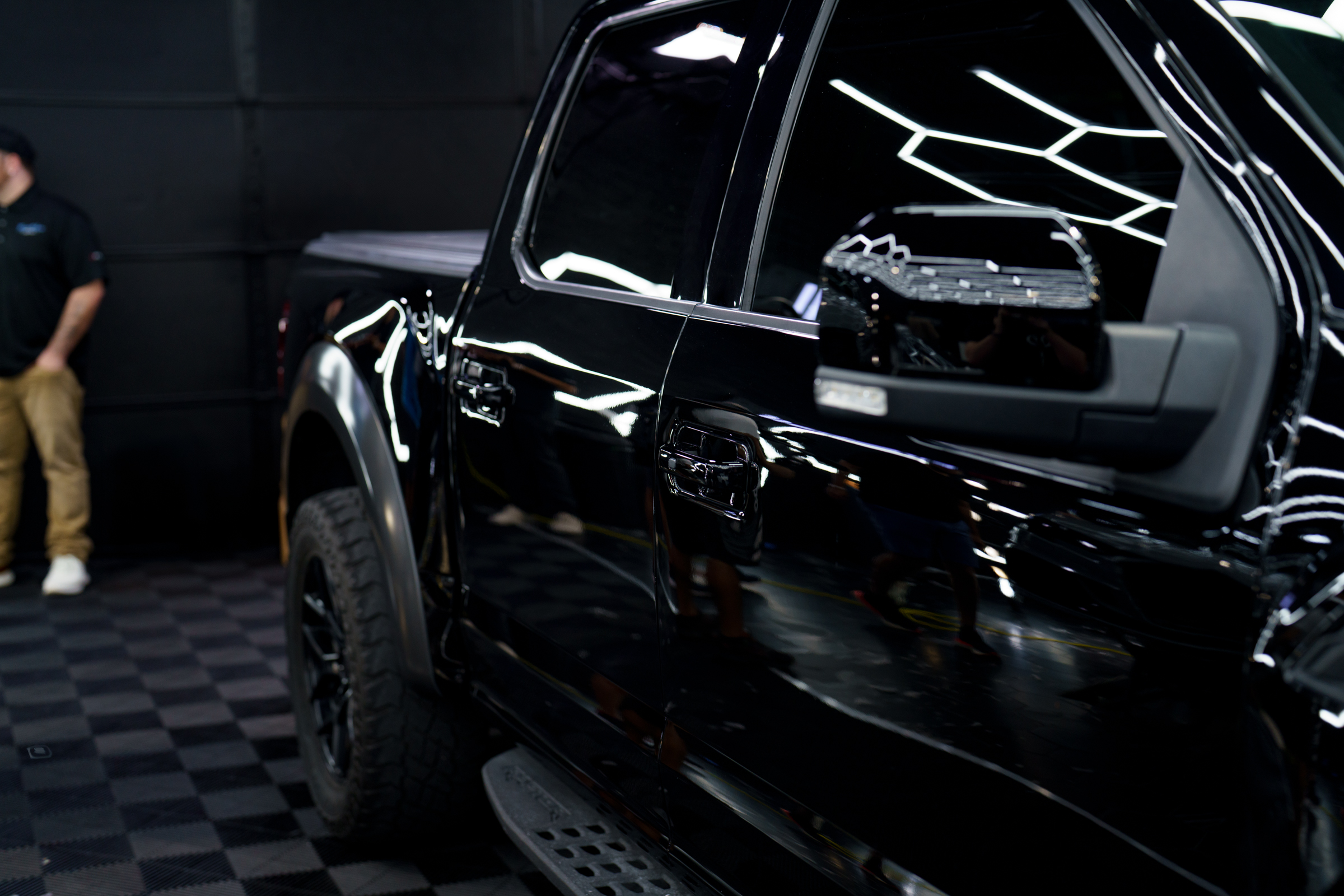 A black ford raptor prepares for a fireball ceramic coating