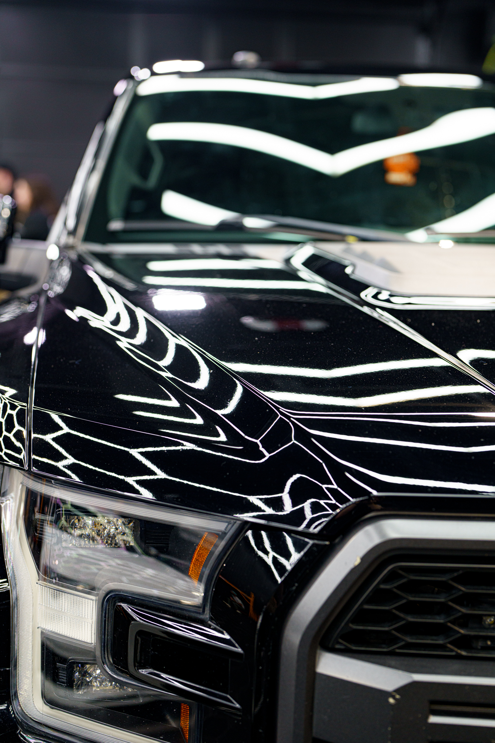 A black ford raptor prepares for a fireball ceramic coating